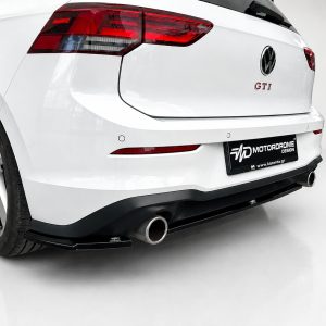 K192-004_4jpg - OPSHOLDERS White VW Golf GTI rear view with aftermarket bumper, dual exhausts, and branded plate reading MOTOR DROME DESIGN.