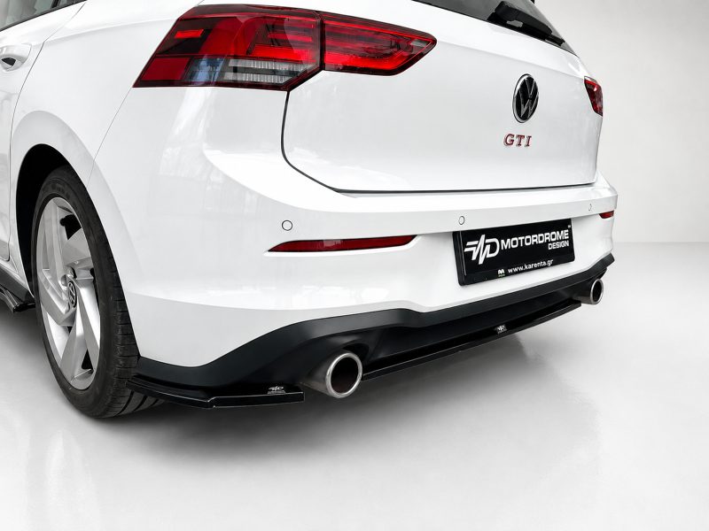 K192-004_4jpg - OPSHOLDERS White VW Golf GTI rear view with aftermarket bumper, dual exhausts, and branded plate reading MOTOR DROME DESIGN.