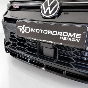 Front view of a black Volkswagen with the VW emblem and a Motordrome Design license plate.