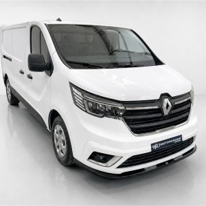 Front three-quarter view of a white Renault cargo van in a studio setting, showing the grille with the Renault emblem and black bumper details.