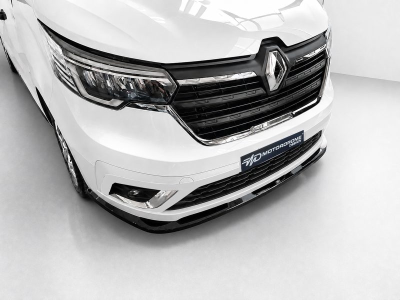 Front view of a white vehicle with a prominent black grille and Renault emblem on the hood.