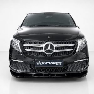 Front view of a glossy black Mercedes SUV with a prominent grille and emblem