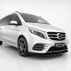 K195-002_2jpg - OPSHOLDERS White Mercedes van shown from the front-right in a studio, with a prominent emblem and alloy wheels central to the image.