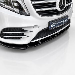 K195-002_3jpg - OPSHOLDERS Front of a white luxury car showing the grille, headlight, and a black front lip spoiler with a dealership plate reading MOTORADOME DESIGN