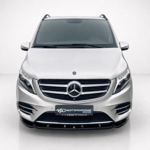 K195-002_4jpg - OPSHOLDERS Front view of a silver Mercedes-Benz SUV in a bright studio, showcasing the chrome grille and emblem.