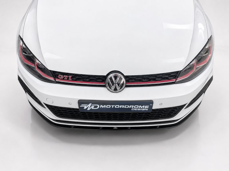 White VW GTI car front view with emblem and black honeycomb grille, Motordrome Design plate visible