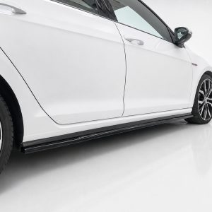 White sports car shown from the side, highlighting the door seam, side skirt, and alloy wheels with red brake calipers.