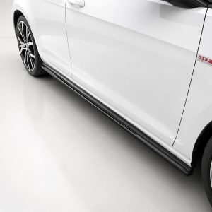 White car side view highlighting the door, wheel, and red GTI badge near the front door.