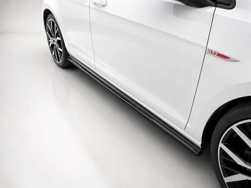 White car side view highlighting the door, wheel, and red GTI badge near the front door.