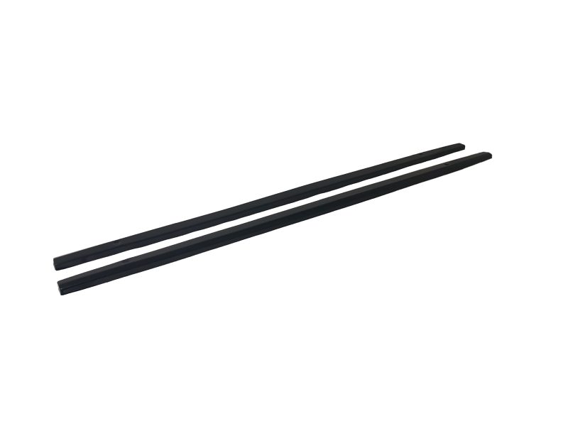 Pair of black chopsticks lying parallel on a white background