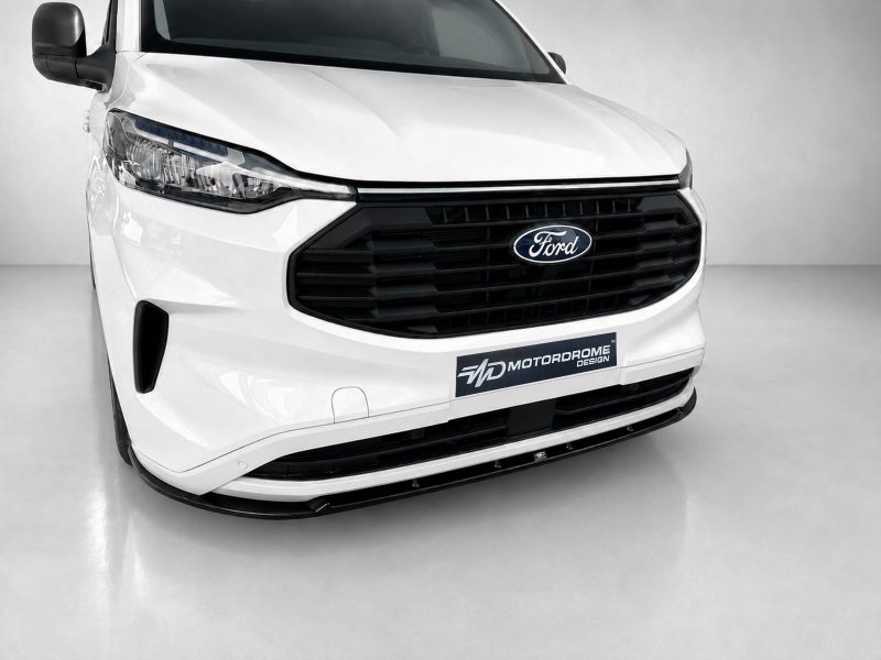 Front view of a white Ford van with a black grille and MotorDrome Design plate on the bumper