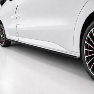 White car viewed from the side showing a sculpted body line and a large multi-spoke wheel with red brake calipers on a glossy surface.