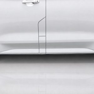 White side view of a van with door seams and a thin chrome trim along the lower edge.
