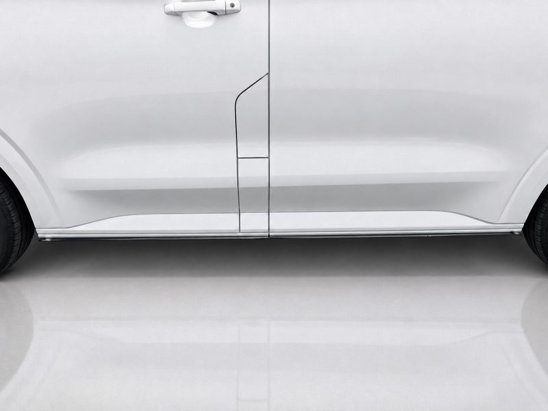 White side view of a van with door seams and a thin chrome trim along the lower edge.