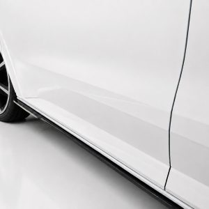 White car side profile focusing on alloy wheel and lower body panel (running board visible).