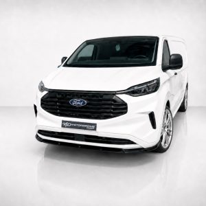 White Ford cargo van shown from a near-front-left angle, featuring a black grille, dark headlights, and a 'Motorrome Design' plate on the bumper
