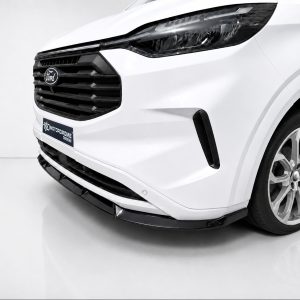 Front-left close-up of a white Ford SUV showing the grille, headlight, and alloy wheel in a glossy studio setting.