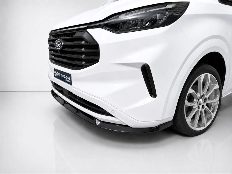 Front-left close-up of a white Ford SUV showing the grille, headlight, and alloy wheel in a glossy studio setting.