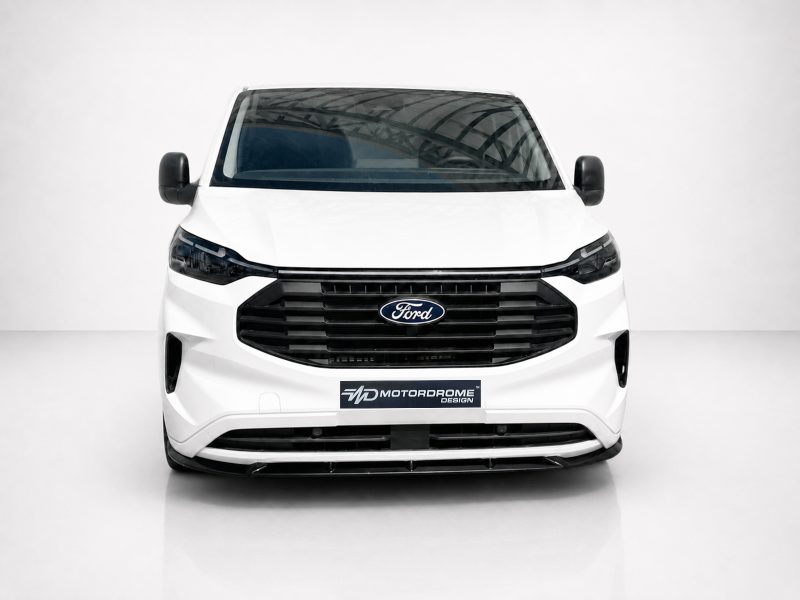 Front view of a white Ford van in a studio, showing black grille and Ford emblem.