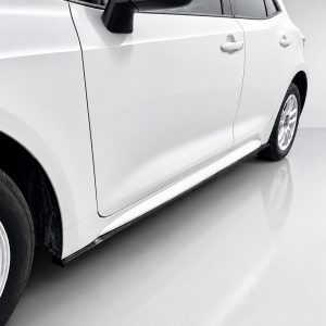 Side view of a white car showing the front and rear doors, black side mirror, and alloy wheels on a glossy floor.