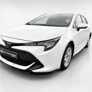 White sedan shown from the front-left in a bright studio, featuring a black front grille and Toyota emblem.