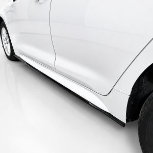 Side view of a white car showing the lower body and running board along the side edge.
