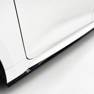 Close-up of a white SUV's lower side, showing the running board and part of the front wheel.