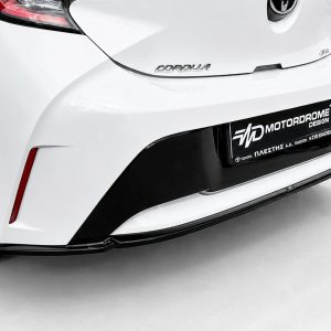 K201-003_4jpg - OPSHOLDERS Rear view of a white Toyota Corolla with a black lower bumper and a dealership plate