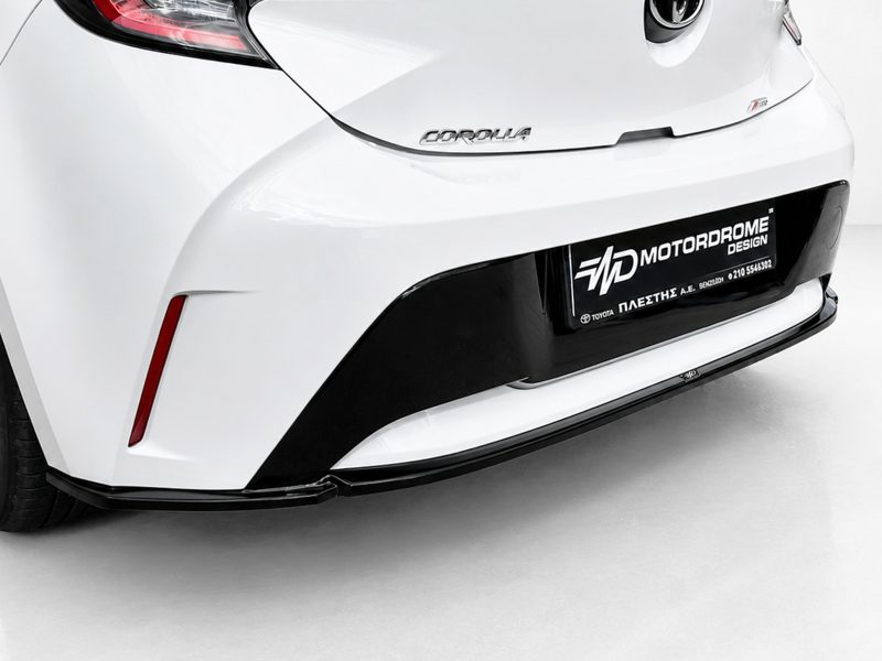 K201-003_4jpg - OPSHOLDERS Rear view of a white Toyota Corolla with a black lower bumper and a dealership plate