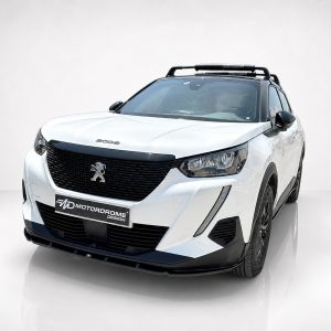 Angled front view of a white Peugeot SUV with a black grille and roof rack in a studio setting