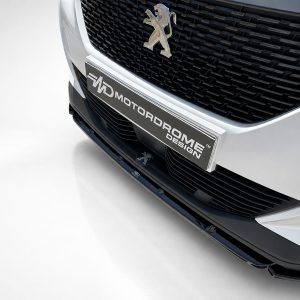 Front view of a silver Peugeot car showing the emblem and a chrome plate reading Motordrome Design on the grille area of the bumper.