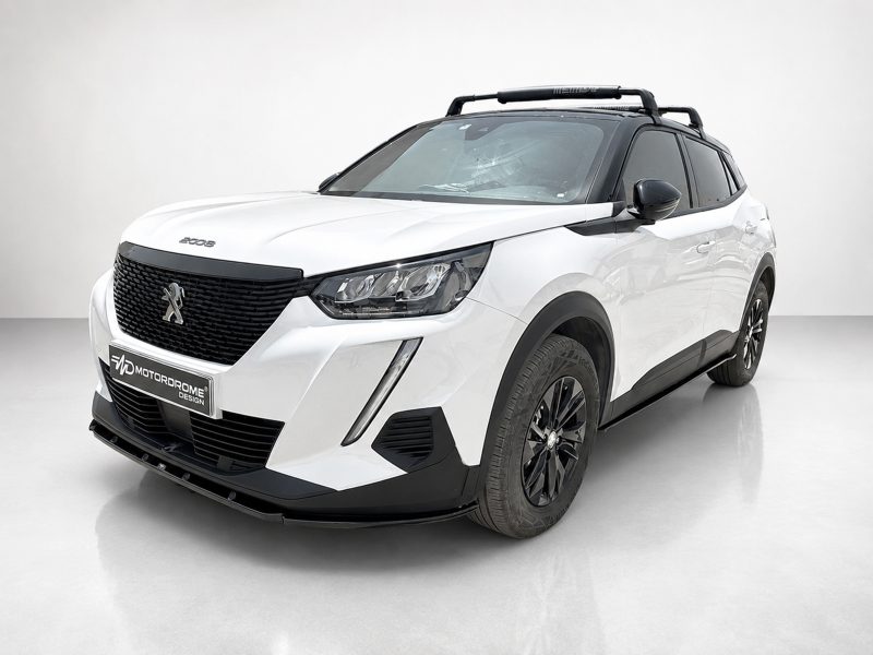 Front three-quarter view of a white Peugeot 5008 SUV with a black grille, roof rack, and dark windows in a studio setting.