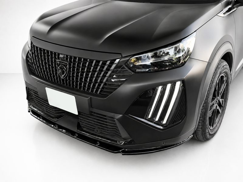 Front view of a black Peugeot SUV with a prominent grille and modern LED headlight cluster.