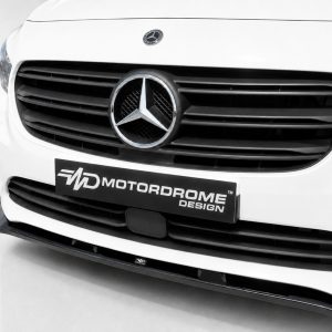 White Mercedes van front with prominent circular emblem, black grille, and a Motordrome Design plate in the center.