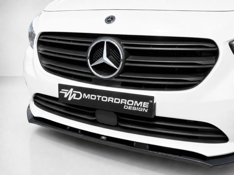 White Mercedes van front with prominent circular emblem, black grille, and a Motordrome Design plate in the center.