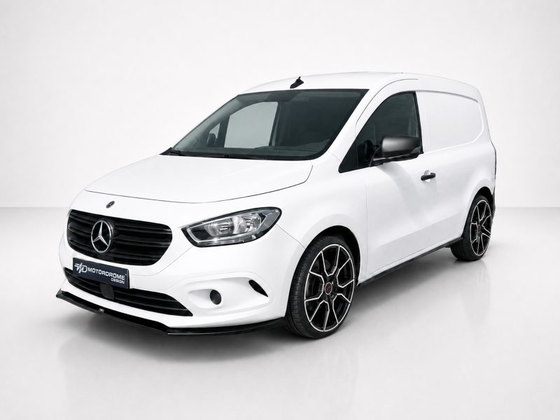 White Mercedes-Benz small cargo van photographed in a studio, showing the front and passenger side with black grille and alloy wheels.