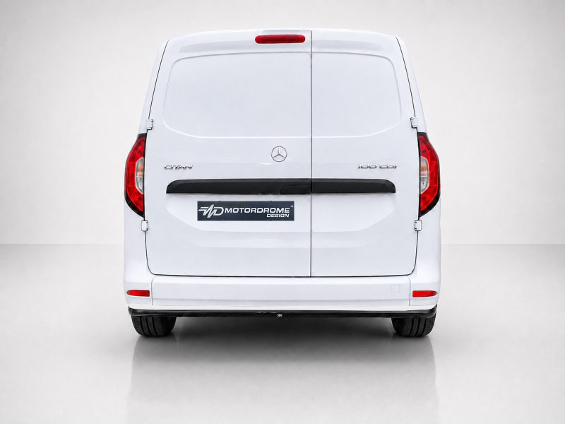 K204-003_3jpg - OPSHOLDERS Rear view of a white Mercedes van with split rear doors and red taillights, featuring an MD Motordrome Design plate on the back.
