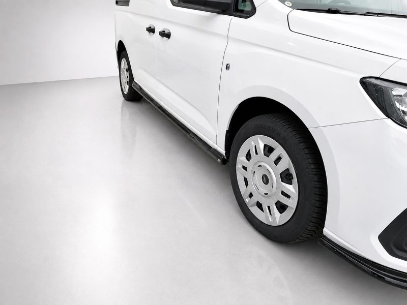 White van shown from the side with a running board and wheel visible on a light gray floor surface.