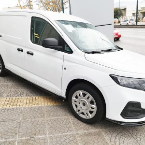 White cargo van parked at an angle on a patterned sidewalk, front to the right, with black side mirrors and trim visible.