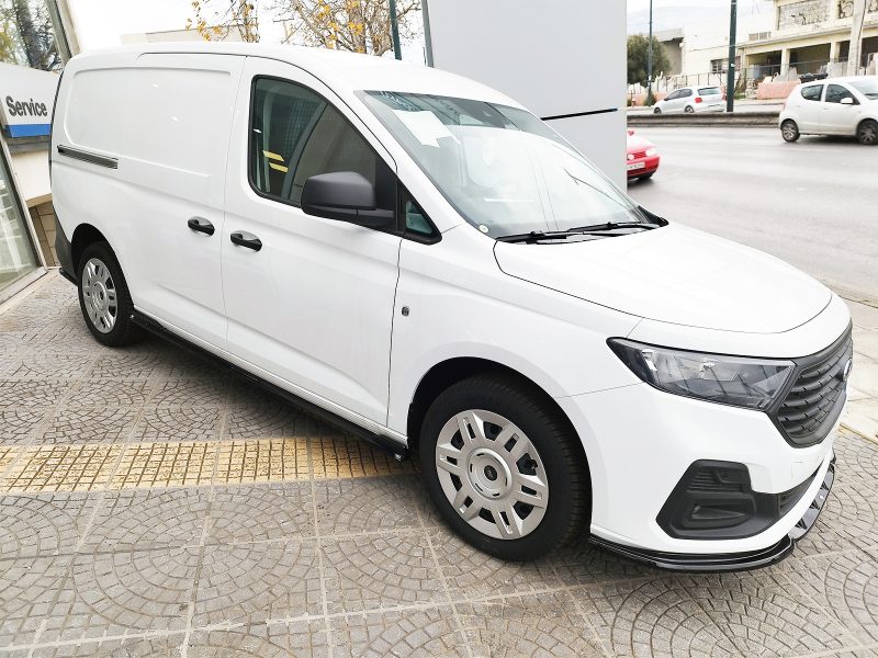 White cargo van parked at an angle on a patterned sidewalk, front to the right, with black side mirrors and trim visible.