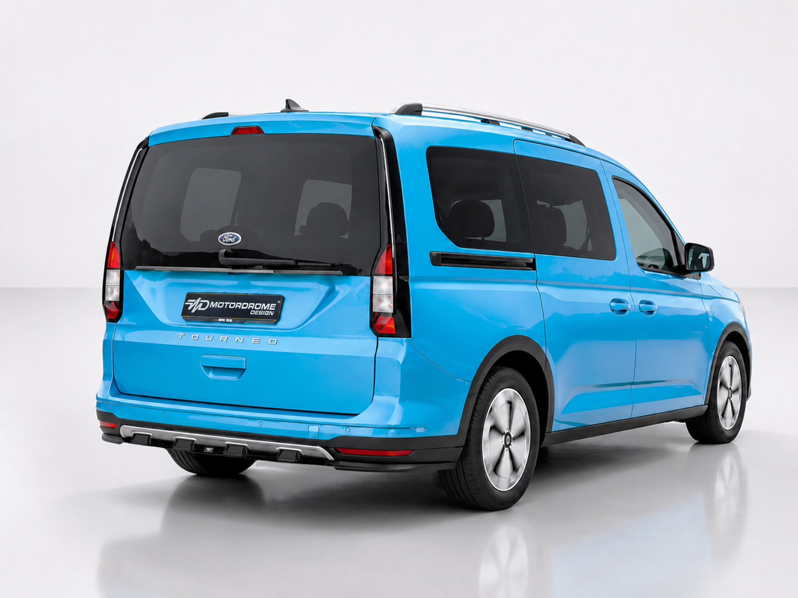K205-003_1jpg - OPSHOLDERS Blue Ford Tourneo van shown from the rear-right, featuring a Motordrome Design plate on the tailgate and dark rear windows.