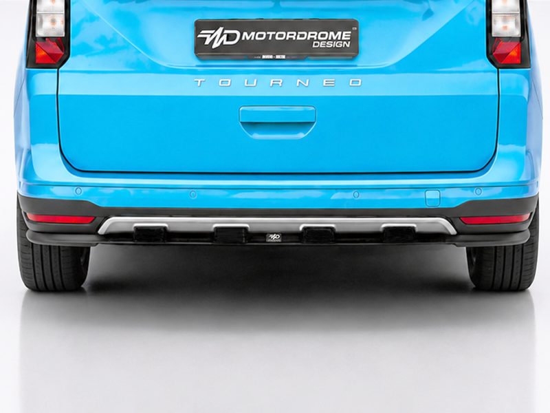K205-003_3jpg - OPSHOLDERS Rear view of a bright blue SUV with 'TOURNED' lettering on the tailgate and a factory bumper.