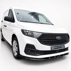 Front three-quarter view of a white Ford cargo van with black grille and headlights in a studio setting