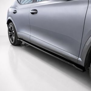 Side view of a gray SUV with a running board and large alloy wheels for a modern look.