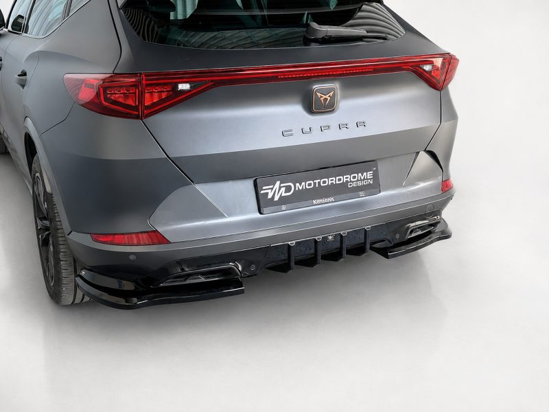 K208-003_3jpg - OPSHOLDERS Rear view of a gray CUPRA SUV showing red taillights, badge, and a custom black rear diffuser with a motordrome design plate.