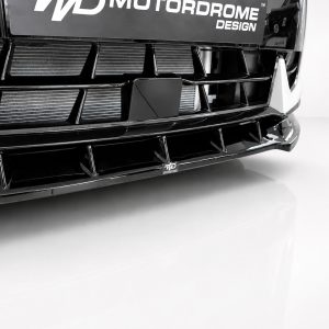 Close-up of a glossy black car front with a bold grille and custom bumper design, showing a small WD logo plate.