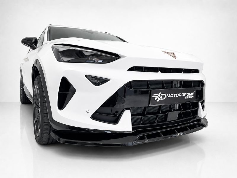 White sports car front view with black grille and emblem, low stance, photographed in a studio.