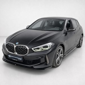 Black BMW sedan in a studio setting, shown from a front three-quarter angle focusing on the grille and headlights