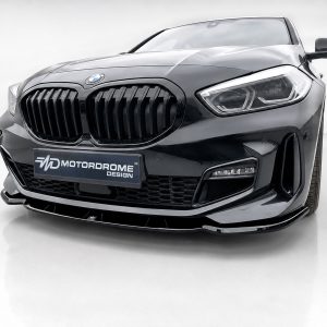 Front view of a black BMW with a large kidney grille and a Motordrome Design plate.