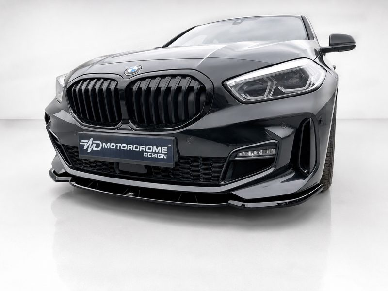 Front view of a black BMW with a large kidney grille and a Motordrome Design plate.